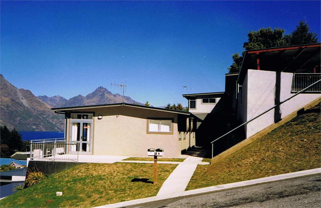 View of unit from street with carport on the right