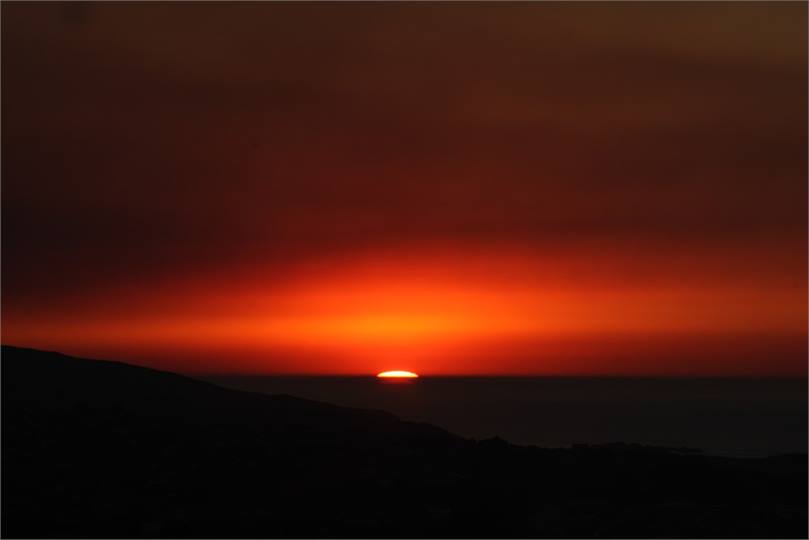 Watch the sun rises beyond the ocean horizon