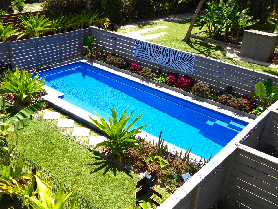 the pool is fenced, gated and landscaped