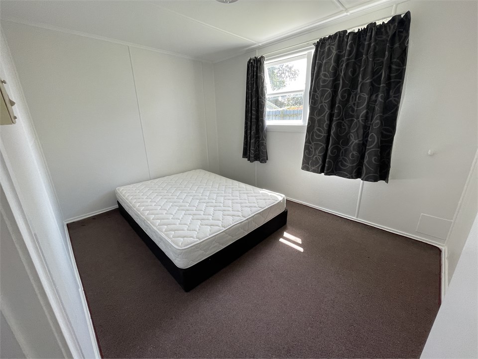 Side room in main lodge with queen bed