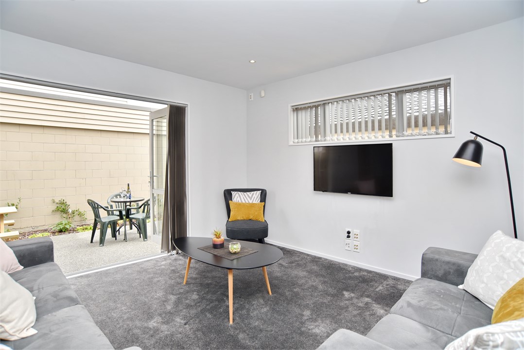 Living area that has a TV and seating areas