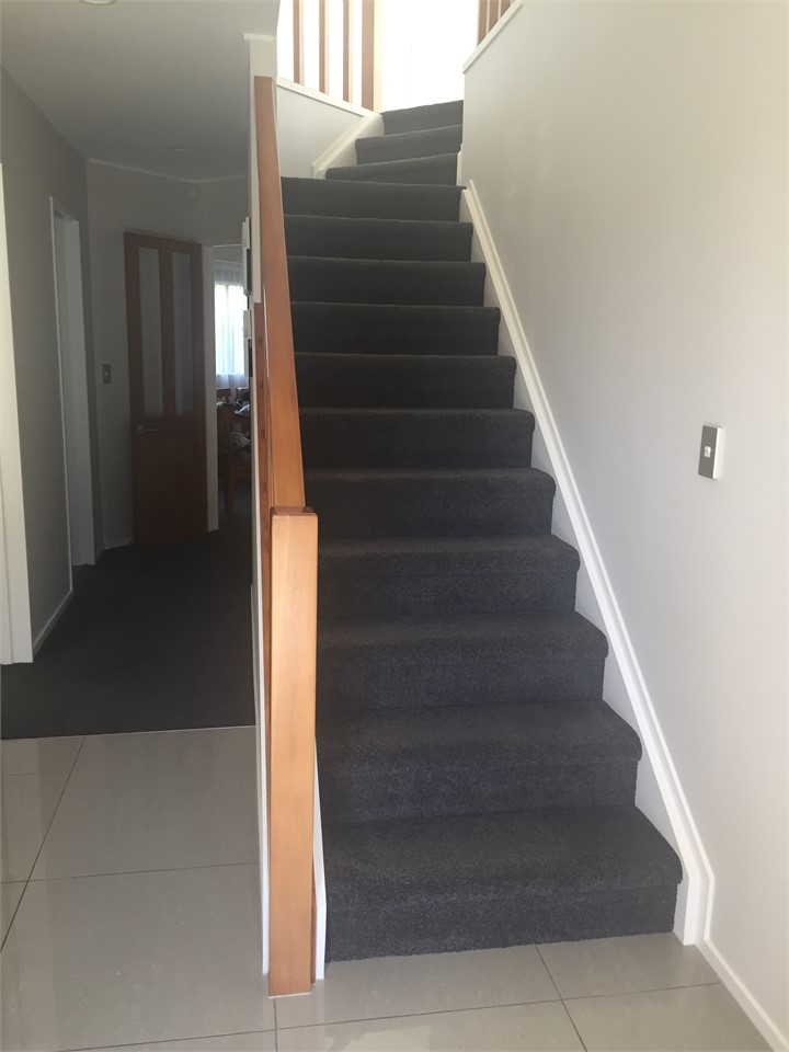 Stairs from front door to upstairs area