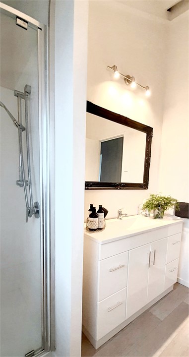 Spacious bathroom with shower gel, shampoo, condit