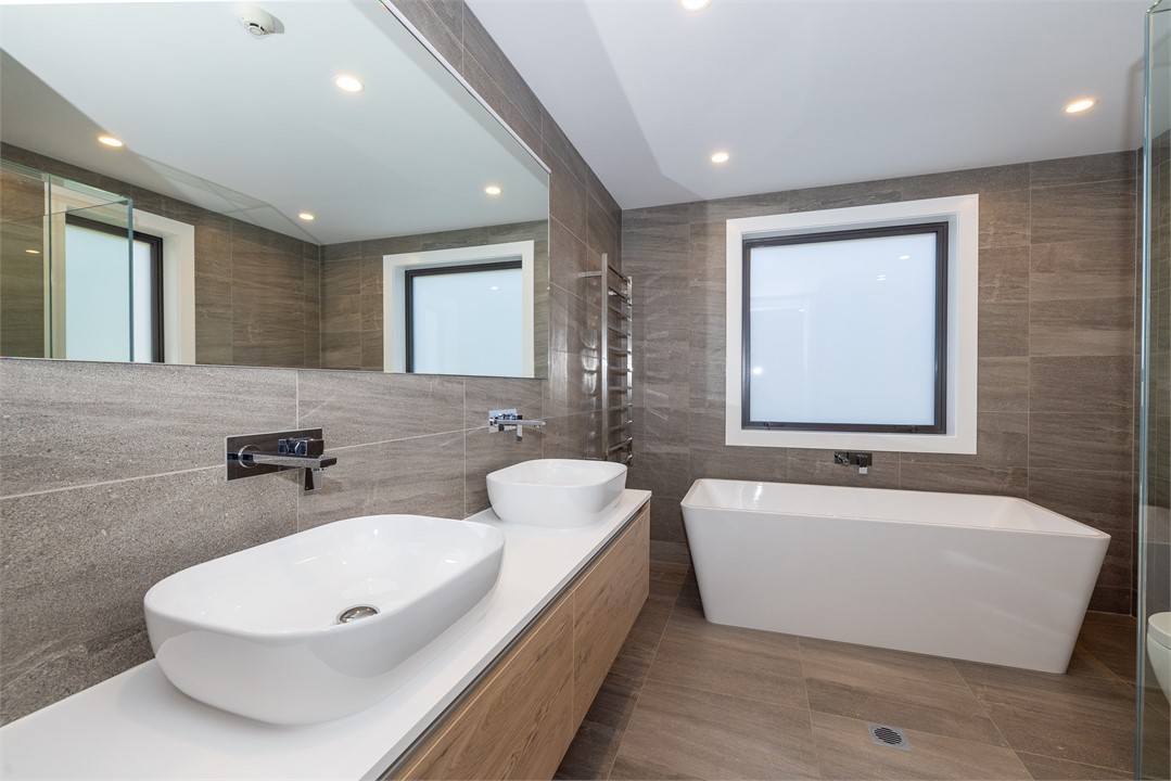 Bathroom 1 has a shower, bathtub and a toilet