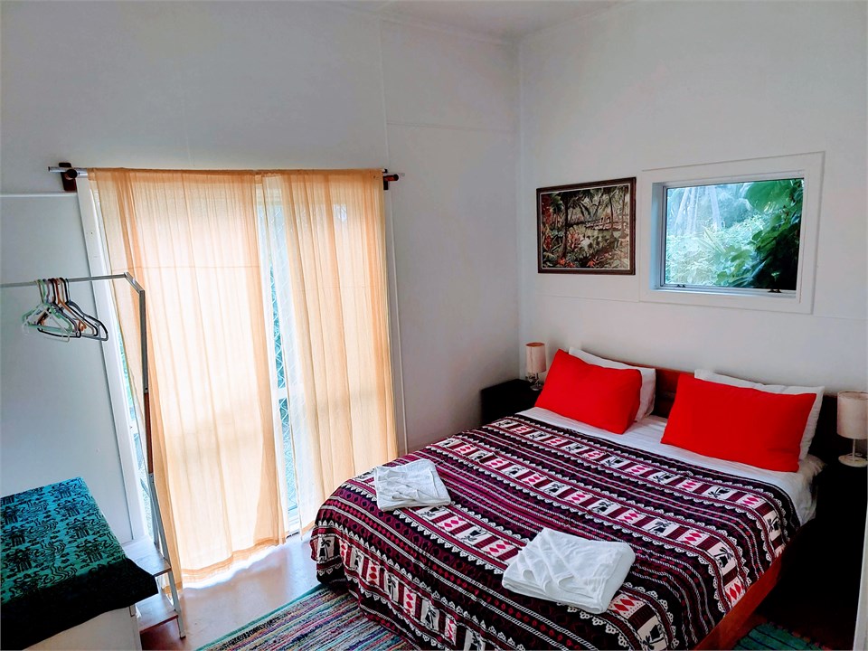 BEDROOM WITH CURTAINS PARTIALLY CLOSED