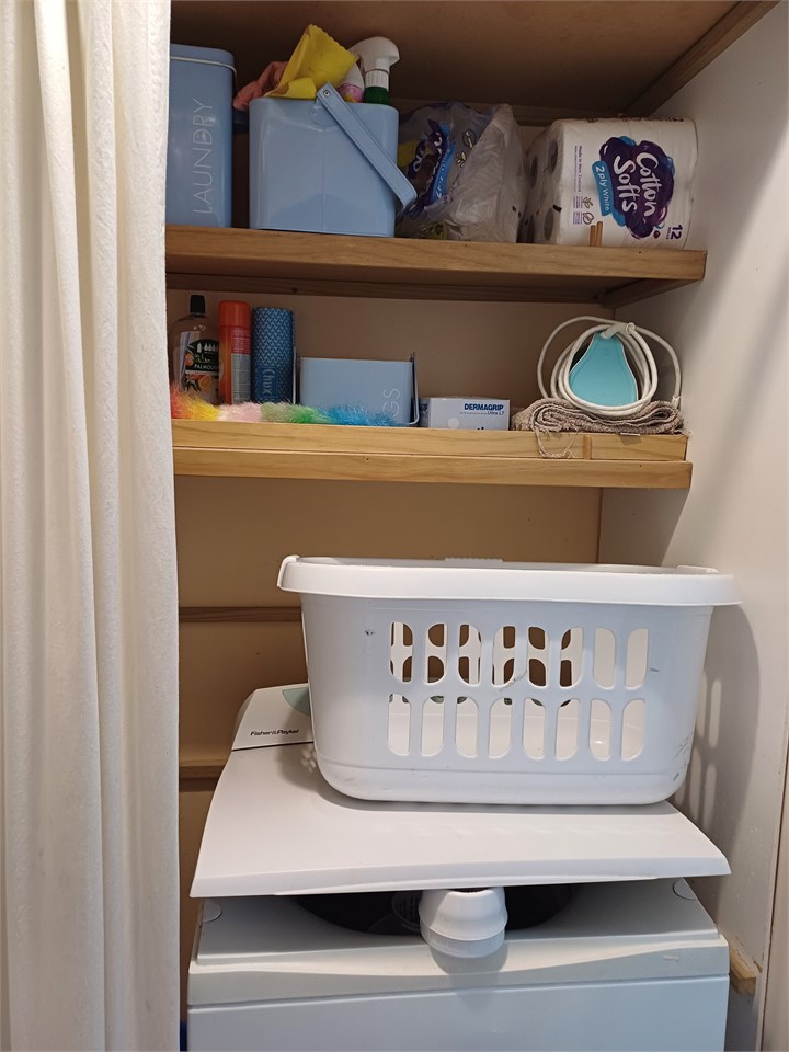 Laundry with large washing machine and iron and ir